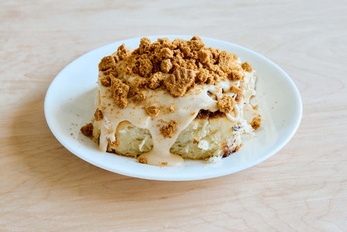 classic cinnamon roll with biscoff cookie butter frosting and crushed biscoff cookie pieces