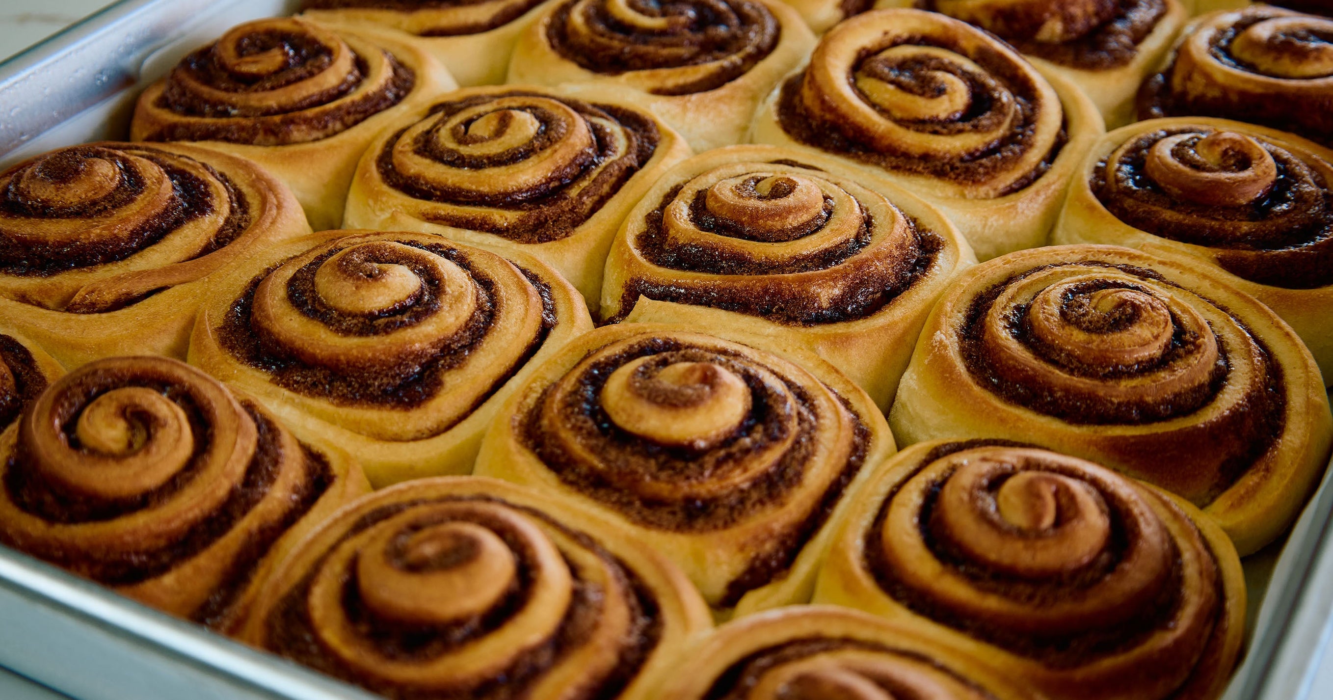 Baked cinnamon rolls in a baking tray